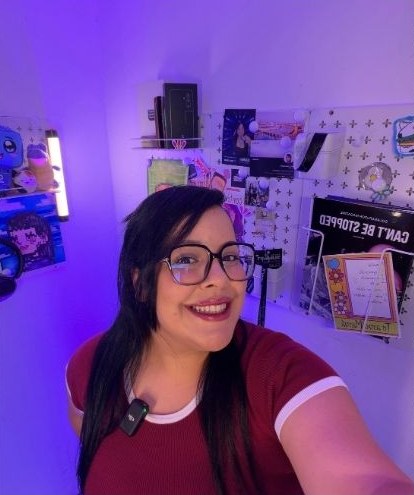 Ari smiling in her purple-lit creator room